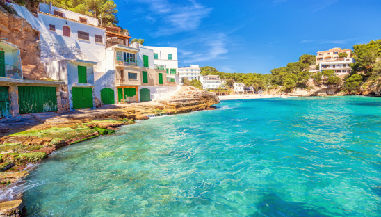 Beautiful traditional boathouses, apartments and beach at Playa Santanyi, located in the south east of Mallorca (Spain).