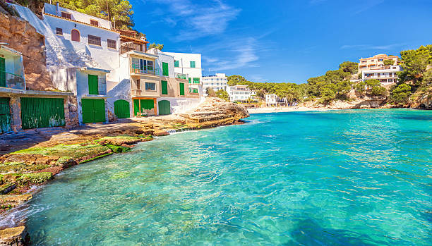 Santanyi Beach - Majorca Beautiful traditional boathouses, apartments and beach at Playa Santanyi, located in the south east of Mallorca (Spain). majorca photos stock pictures, royalty-free photos & images