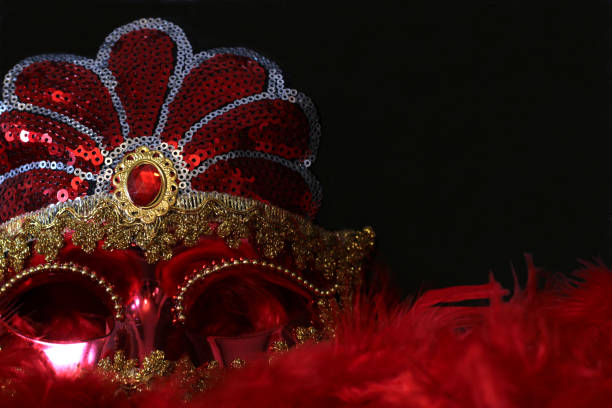 istock Red and gold carnival mask on black background 1874428336