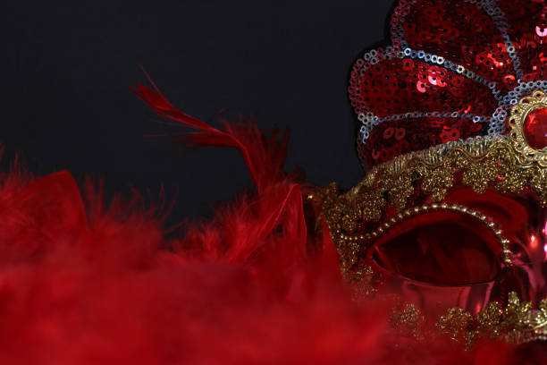 istock Red and gold carnival mask on black background 1874429378