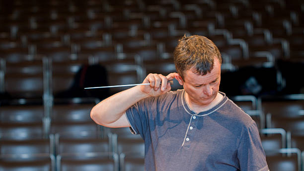 Orchestra conductor consulting his score stock photo