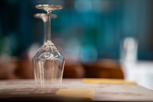 Close-up shot of wine glasses on the table in luxury restaurant without people