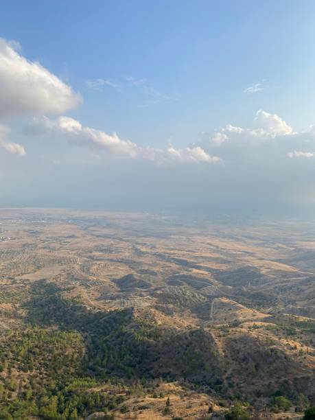 istock It is an endless plain with hills, trees, sky and clouds visible from a high mountain slope. 1874434888