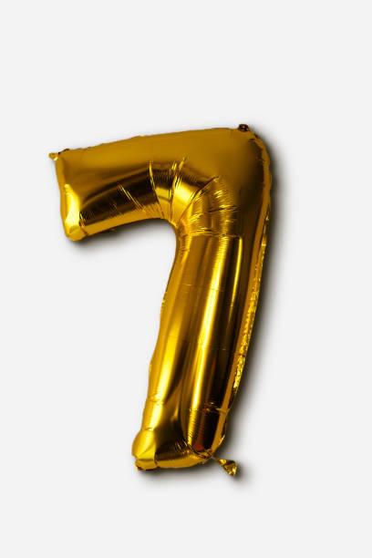 istock Gold balloon number seven on white background. 1874435401