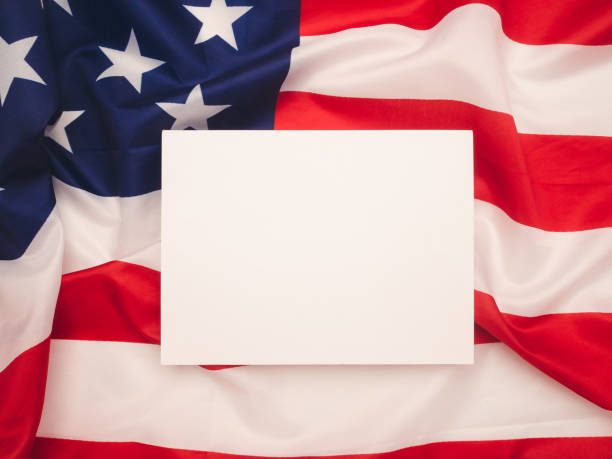 istock A blank white paper over the American flag background. 1874453274