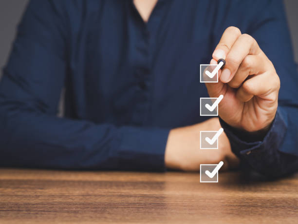 istock A businessman ticks correct sign white marks in checkboxes while sitting at the table. 1874455926