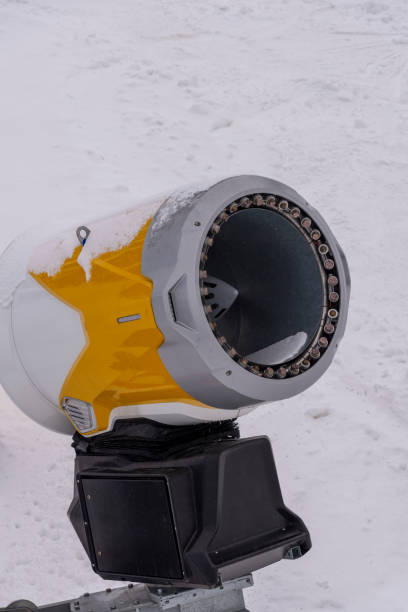 istock Orange machine for making artificial snow. Artificial snowmaking system. Snow cannon in winter mountains.  A high power snow cannon for making artificial snow. 1874458601