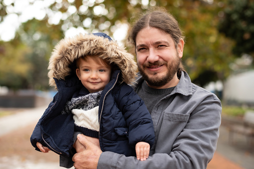 40 years old father with his 1 year old son in autumn day portrait