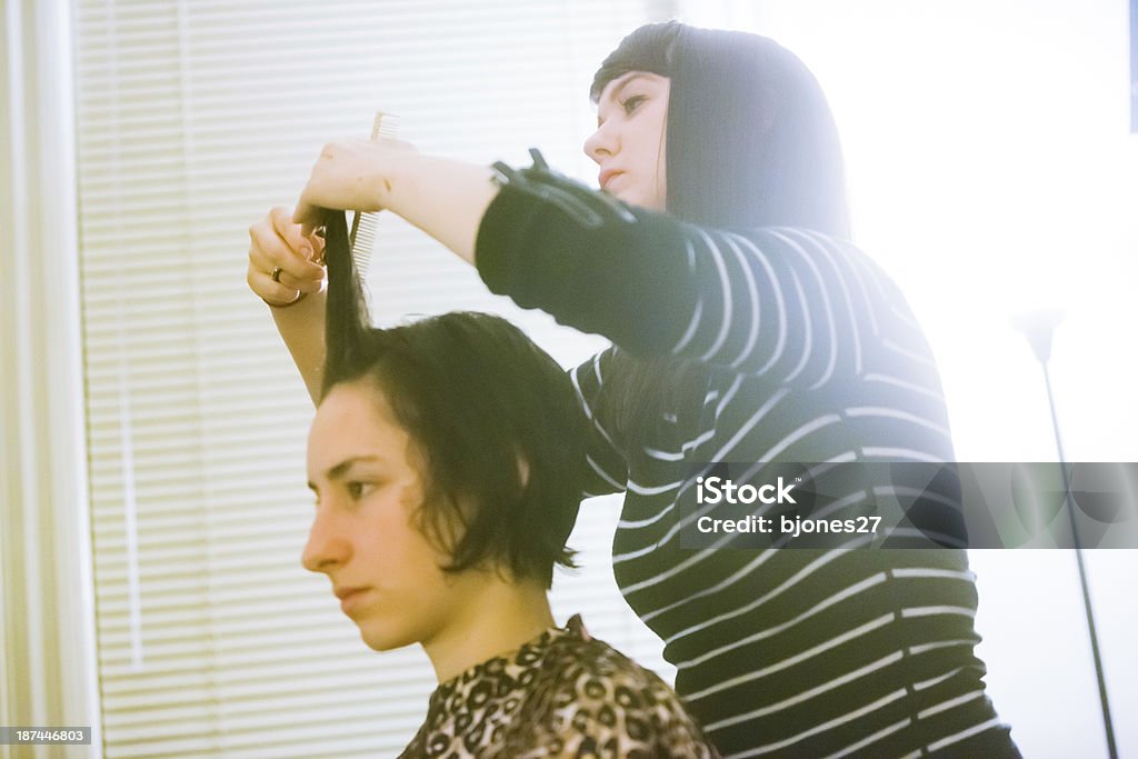 Young Women Hair Cut young woman getting her hair cut by a female stylist 20-29 Years Stock Photo