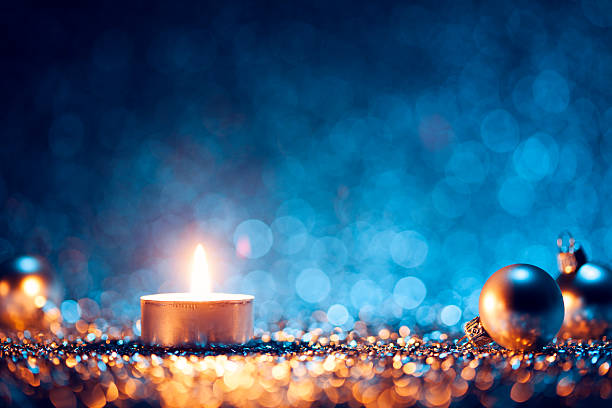 istock A lighted candle with Christmas balls at the sides 187447582