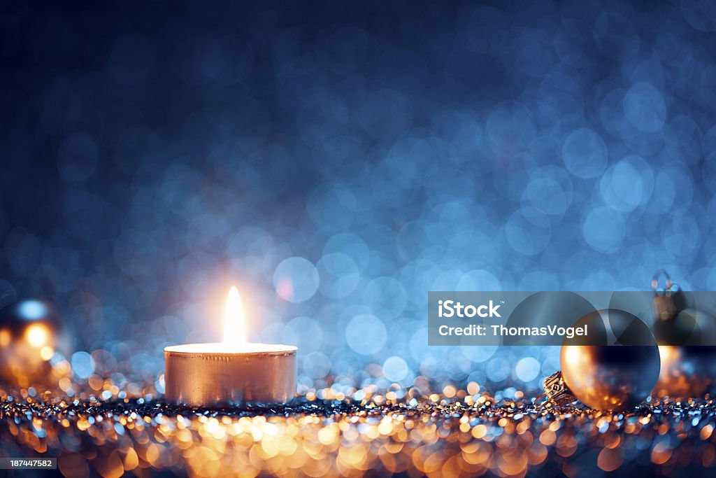 A lighted candle with Christmas balls at the sides http://thomasvogel.eu/istock/is_christmas.jpg Blue Stock Photo