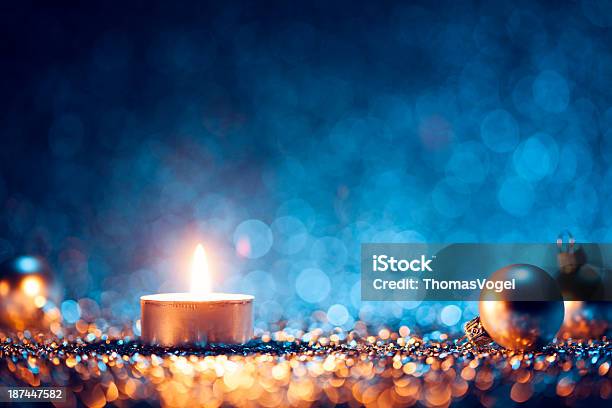A Lighted Candle With Christmas Balls At The Sides Stock Photo - Download Image Now - Blue, Christmas, Backgrounds