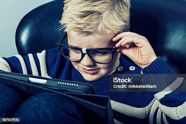 Boy With Geek Glasses And A Digital Tablet Stock Photo - Download Image Now - 6-7 Years, Book, Boys