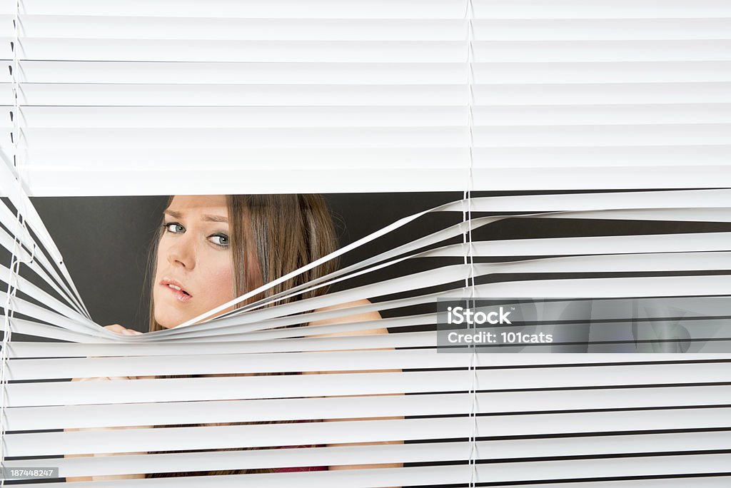 jealousy Woman behind blinds stalking 20-29 Years Stock Photo