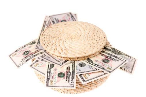 Basket full with fifty dollars bill. Isolated on white,