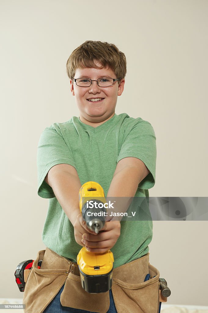 Boy with Tools A boy holding a power tool drill Aspirations Stock Photo