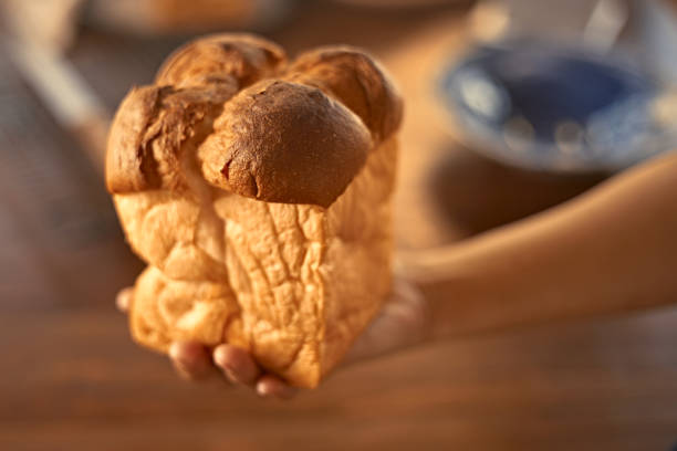 istock Female hands holding homemade fresh bread 1874489060