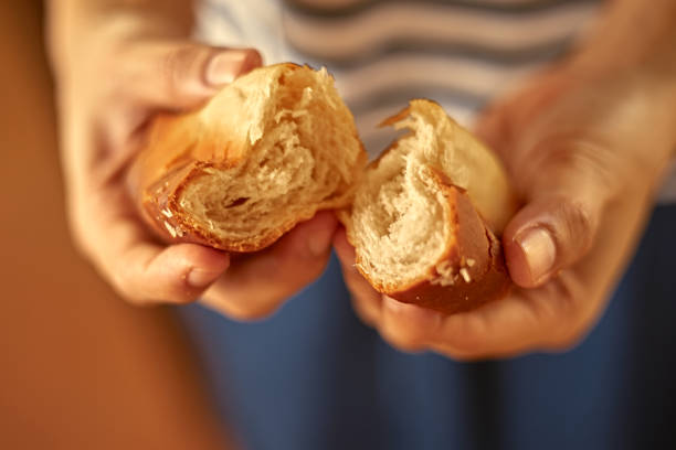 istock Female hands holding homemade fresh bread 1874494892