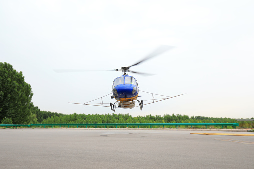 Sikorsky S-92 helicopter in parked at Sola airport in Stavanger, Norway. Used by the oil industry in the North Sea to transport workers to and from offshore oil and gas installations. Photos taken from roads through wire fence.