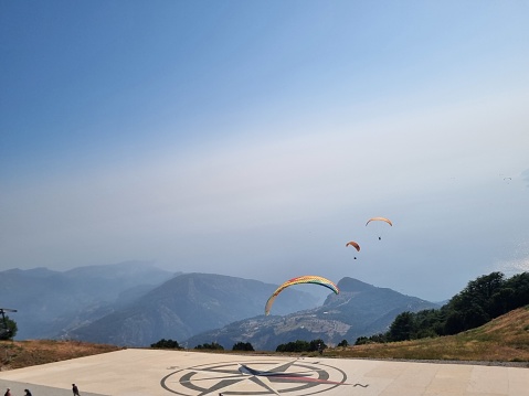 Atibaia, SP, Brazil | April 19, 2019: Paramotors seen from the Pedra Grande (Big Rock) in the city of Atibaia. This place is an important tourist attraction in the state of São Paulo, and it is a famous launch pad for hang-gliders and paragliders.