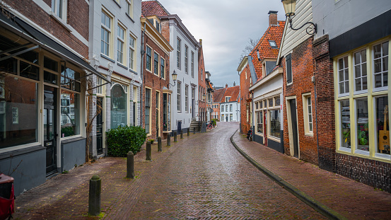 Empty cobblestone city street, surrounded by historic medieval buildings in the old town of Amersfoort. Holland in the Netherlands, Europe.