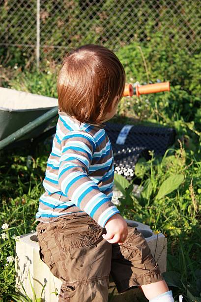 istock little boy in the garden 187450756