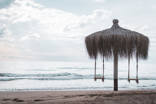 Wooden swing with beach view on the beach of the resort hotel