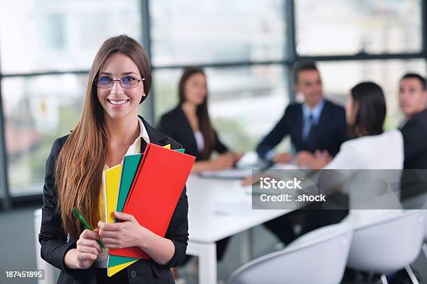 Business Woman With Her Staff In Background At Office Stock Photo - Download Image Now