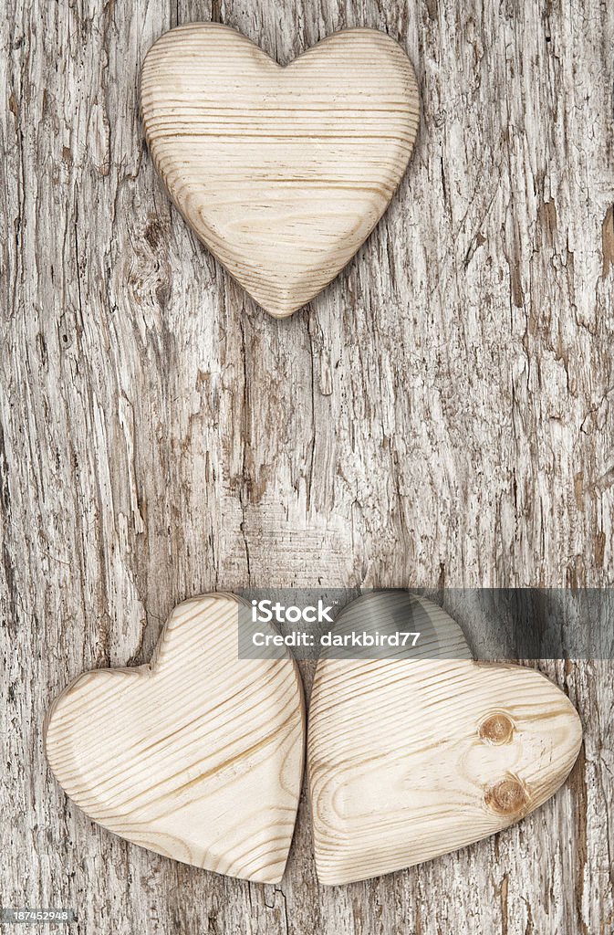 Three wooden hearts on the old wood Three wooden hearts on the old wood background Ancient Stock Photo