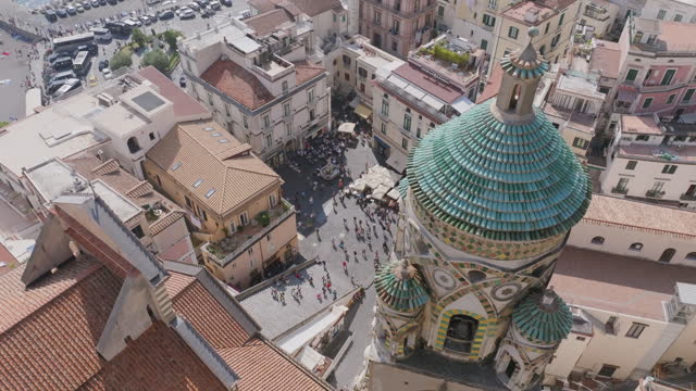 Slow aerial pan of the tower of Chiesa di Santa Maria Assunta in Positano, Italy.