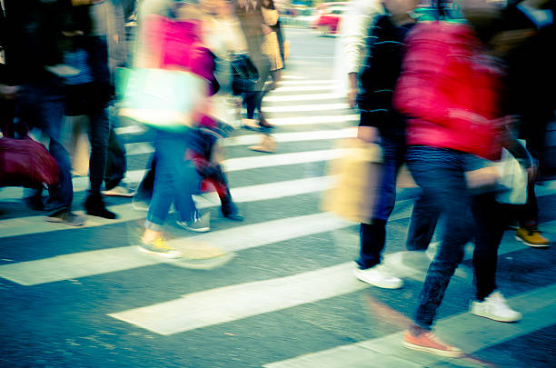 istock people crowd on zebra crossing street 187455444