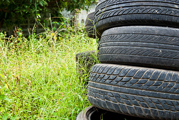 istock Old road tires stacked on grass land 187455498
