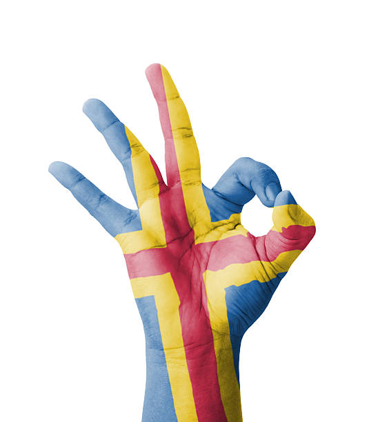 Hand making Ok sign, Aland flag painted stock photo