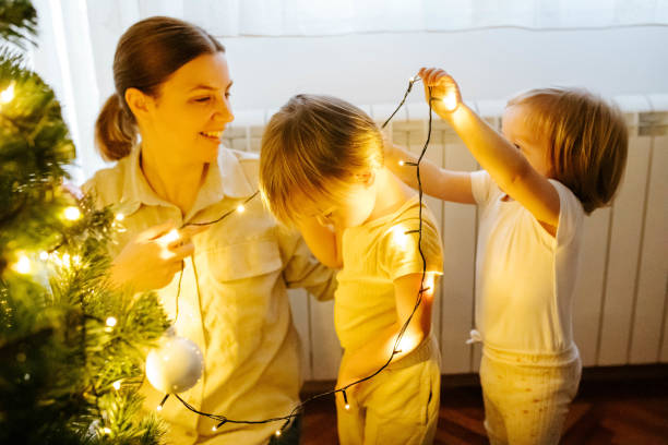 istock Children helping their mother with the Christmas tree 1874585539