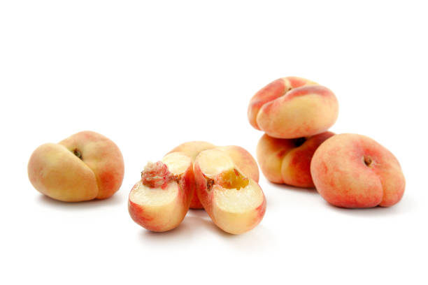 istock Half and several whole saturn peaches or flat peaches isolated on white background with clipping path. 1874598638