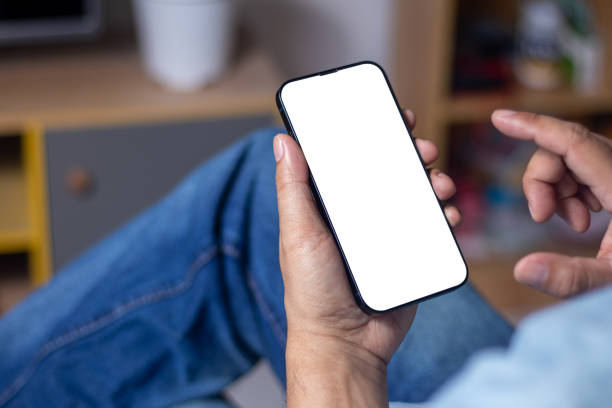 istock Close-up of a man relaxing while sitting in a coffee shop and using his smartphone. white screen smartphone 1874603662