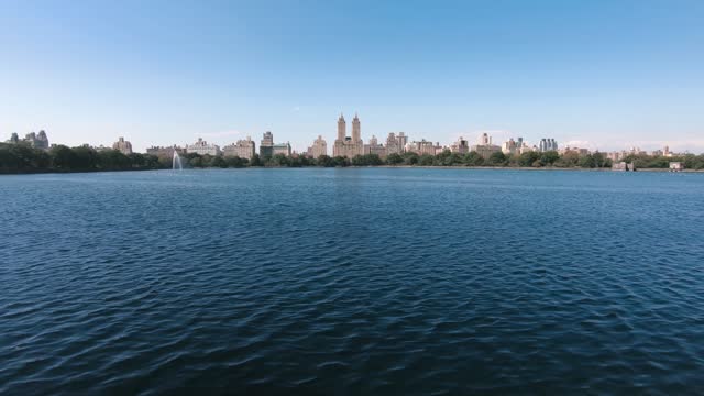 Panorama of the Central Park and the Jacqueline Kennedy Reservoir with a skyline of New York City in midtown Manhattan, the famous SanRemo building in the background