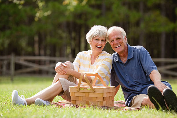 istock Smiling Senior Couple Sitting In Park 187463252