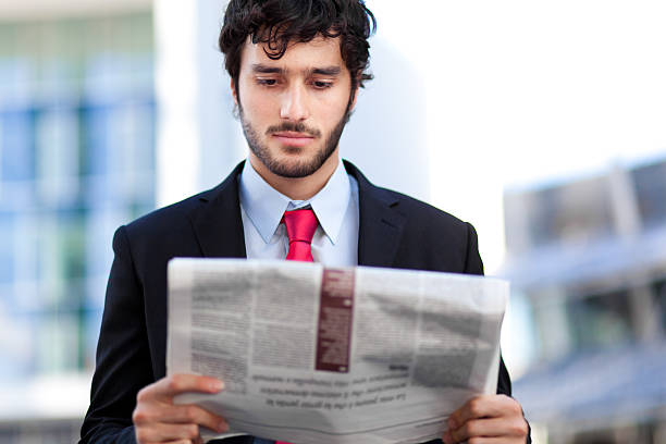 istock Young businessman reading a newspaper 187463650