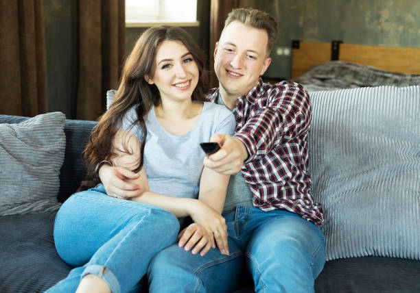 istock Young couple in love drinking red wine in house kitchen 1874640389