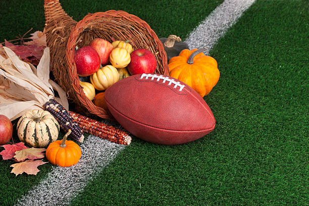 istock Football with cornucopia on a grass field 187464736