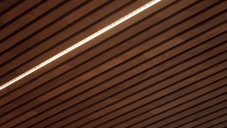 Ceiling with wooden planks and led light lamp at house