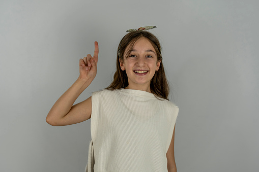 Girl smiling with white background.