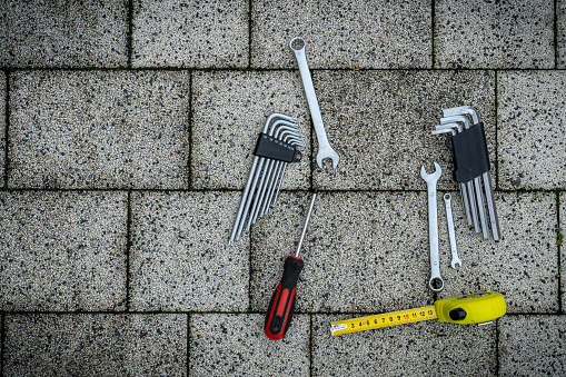 Various repair tools. Must-have men. Equipment for building. Repair tool kit. Grey background top view pattern copy space