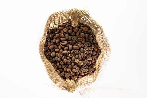 Coffee bag coffee beans in canvas coffee sack isolated on white background