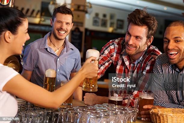 Friends Drinking Beer At Counter In Pub Stock Photo - Download Image Now - 20-29 Years, 25-29 Years, Adult