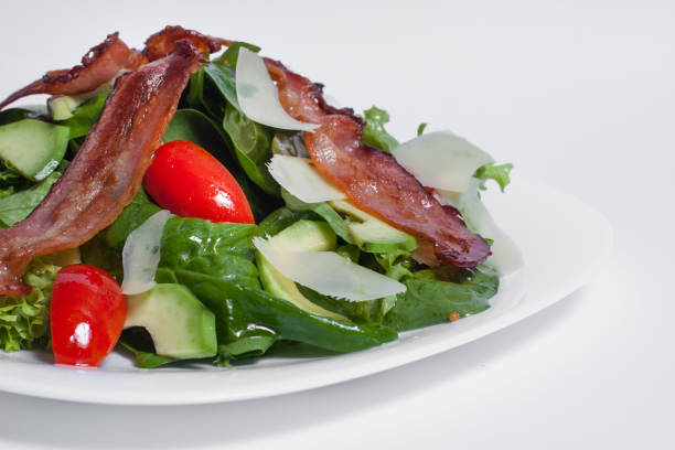tasty green fresh salad with bacon isolated. High quality photo