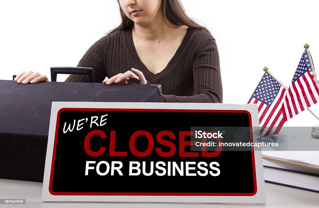 Office Worker with a Closed Sign Because of Goverment Shutdown woman with a desk sign showing closed for business Federal Building Stock Photo