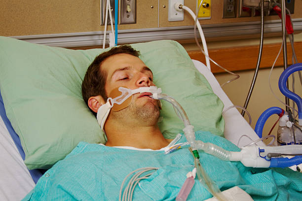 Patient on respirator Patient in hospital on respirator medical ventilator photos stock pictures, royalty-free photos & images