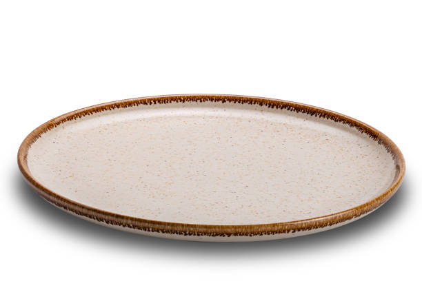 istock High angle view of single empty round spotted brown ceramic plate with brown edge. 1874689482